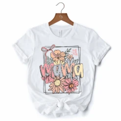 Floral Mama Coquette Bow Pastel T-Shirt, White And Natural Boho Tee With Spring Flower -Eds Plant Shop floral mama coquette bow pastel t shirt white and natural boho tee with spring flower 701552